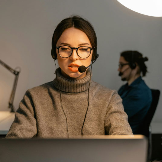 woman-operator-headset woman-looking-at-laptop